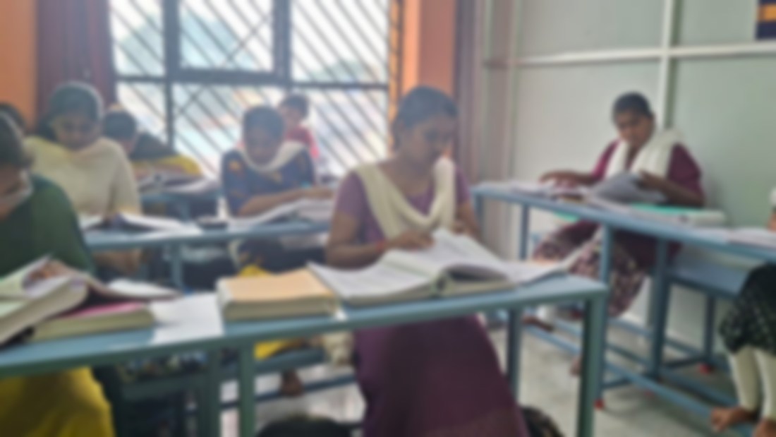 Students working with ICD-10 and CPT code books in class